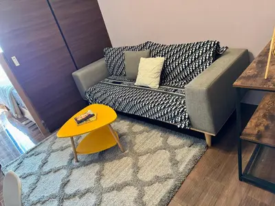 a living room with a couch and a yellow table at City Bliss Chill Vibes Makati 5338 Netflix Swim Gym Park Superfast Net in Manila