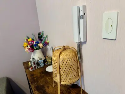 a room with a table and a refrigerator with a vase of flowers at City Bliss Chill Vibes Makati 5338 Netflix Swim Gym Park Superfast Net in Manila