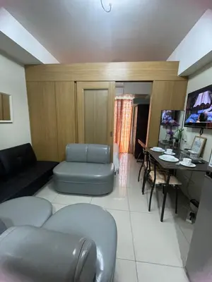 a living room with a couch and a table at 1bedroom Pool view 1441 shell residence with balcony in Manila