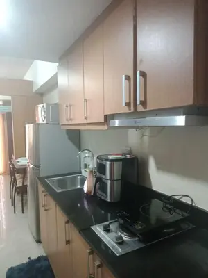 a kitchen with a sink and a coffee maker on a counter at 1bedroom Pool view 1441 shell residence with balcony in Manila