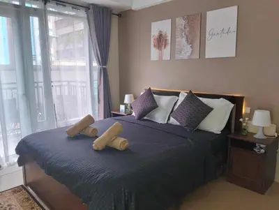 a bedroom with a bed with two wooden logs on it at The Chic Studio at 150 Near NAIA Terminal 3 in Manila