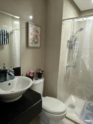 a bathroom with a shower and a toilet and a sink at The Chic Studio at 150 Near NAIA Terminal 3 in Manila