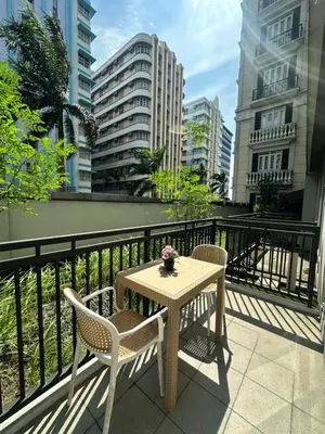 a table and chairs on a balcony with buildings at The Chic Studio at 150 Near NAIA Terminal 3 in Manila