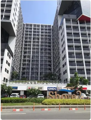 a large building with a sign in front of it at Iyashi Pod in Manila