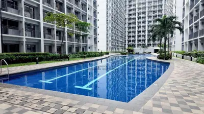 a large swimming pool in the middle of a building at Iyashi Pod in Manila