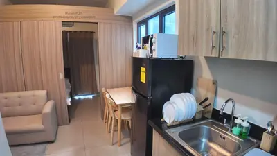 a small kitchen with a sink and a refrigerator at Iyashi Pod in Manila