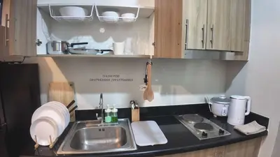 a kitchen with a sink and a counter top at Iyashi Pod in Manila