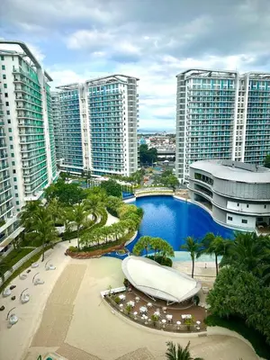 an aerial view of a resort with a pool and buildings at Beach Condo at Azure Urban Resort with SmartTV in Manila