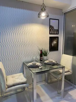 a dining room with a table and two chairs at Beach Condo at Azure Urban Resort with SmartTV in Manila