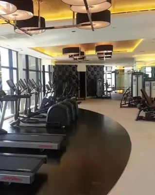 a gym with rows of treadmills and elliptical machines at The Gramercy Residences NEW Sleek 1BR Suite, 600mbps Wifi, Netflix & FREE Amenities in Manila