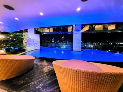 a bar with a view of a city at night at The Gramercy Residences NEW Sleek 1BR Suite, 600mbps Wifi, Netflix & FREE Amenities in Manila