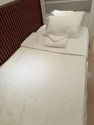 a white bed with white sheets and pillows at Cozy Two-Bedroom Suite, Coast Residences, Pasay in Manila
