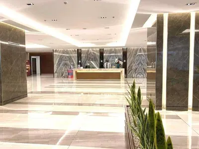 a lobby with a reception desk in a building at Cozy Two-Bedroom Suite, Coast Residences, Pasay in Manila