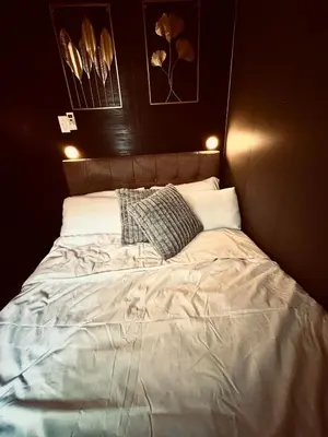 a large bed in a room with lights on it at Air Residences Luxury Condo with Balcony Netflix Wifi in Manila