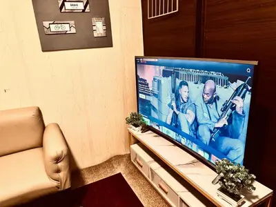 a living room with a large flat screen tv at Air Residences Luxury Condo with Balcony Netflix Wifi in Manila
