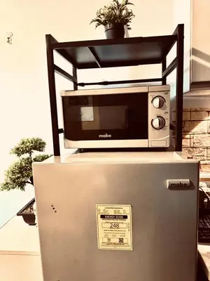 a microwave sitting on top of a refrigerator at Air Residences Luxury Condo with Balcony Netflix Wifi in Manila