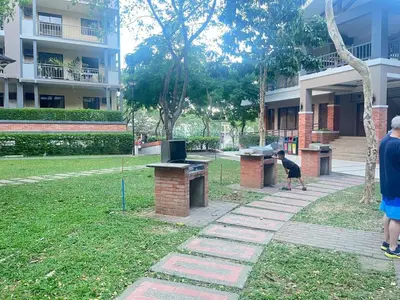 a dog standing in a park next to a building at Acacia Estates' The Getaway Taguig, Evergreen in Manila