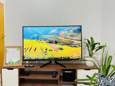 a flat screen tv sitting on top of a tv stand at Acacia Estates' The Getaway Taguig, Evergreen in Manila