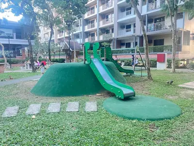 a playground in a park with a green slide at Acacia Estates' The Getaway Taguig, Evergreen in Manila
