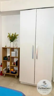 a large white cabinet in a room with a shelf at Azure Residences Staycation - Bahamas tower in Manila
