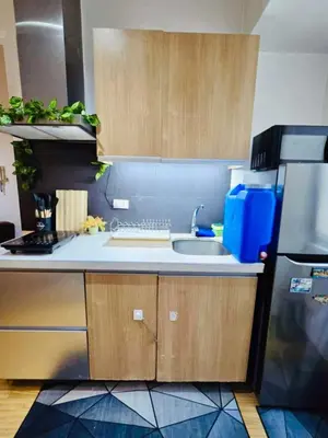 a small kitchen with a sink and a refrigerator at Azure staycation by Marco in Manila