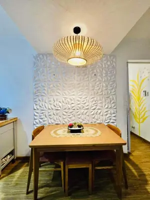 a table with chairs and a chandelier in a room at Azure staycation by Marco in Manila