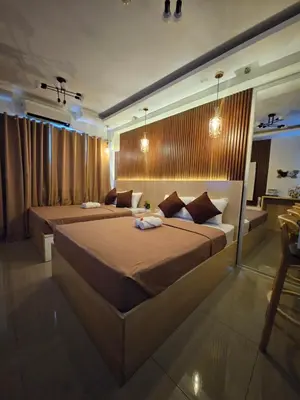a large bedroom with two beds in a room at Soleil Suite 10 mins to SM Moa, Pasay - 2 beds in Manila