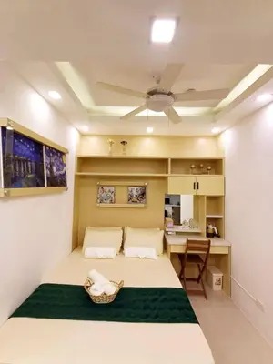 a bedroom with a large bed and a table at My Staycation moa area S RESIDENCES TOWER 1 in Manila