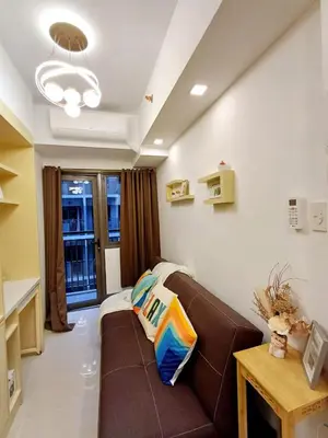 a living room with a brown couch in a room at My Staycation moa area S RESIDENCES TOWER 1 in Manila