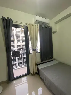 a bedroom with a bed and a large window at Shore 2 Residence Tower 3 in Manila