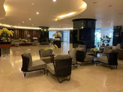 a lobby with chairs and a table in a building at Shore 2 Residence Tower 3 in Manila