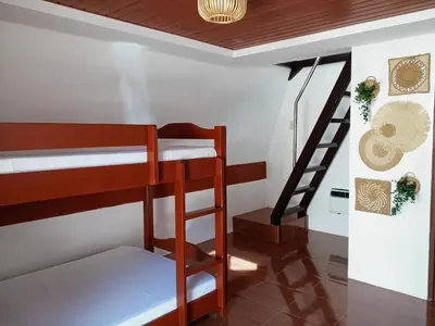 a room with two bunk beds and a staircase at tierra de segundo in Binangonan