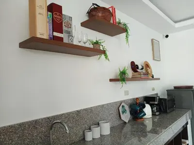 a kitchen counter with a sink and shelves at tierra de segundo in Binangonan