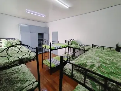 a room with three bunk beds in it at BahayMandaragat in Manila