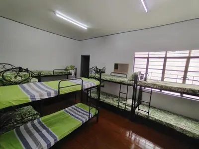 a room with three bunk beds and a window at BahayMandaragat in Manila