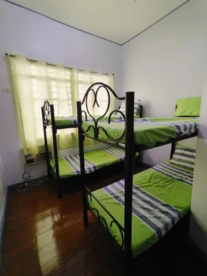 two bunk beds in a room with a window at BahayMandaragat in Manila