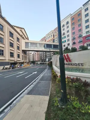 an empty street in a city with tall buildings at LDN Secret 1BR across NAIA Terminal 3 in Manila