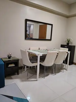a dining room with a table and chairs and a mirror at LDN Secret 1BR across NAIA Terminal 3 in Manila