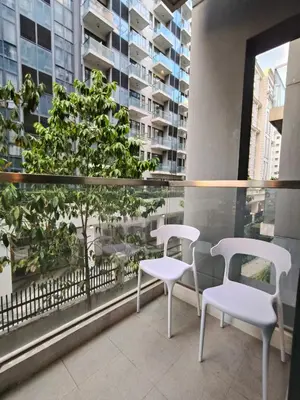 two white chairs and a table on a balcony at LDN Secret 1BR across NAIA Terminal 3 in Manila