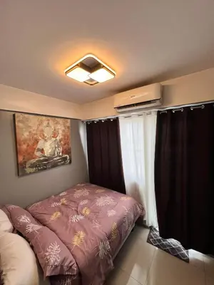a small bedroom with a bed and a window at Staycation at SHORE 1005 in Mall of Asia near Airport in Manila