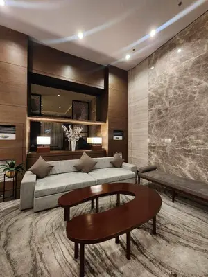 a living room with a couch and a table at Modern condo near US Embassy in Manila