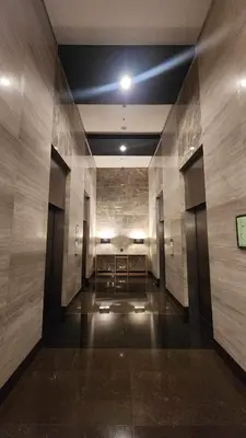 a hallway with a table in the middle of a building at Modern condo near US Embassy in Manila