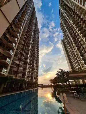 two tall buildings with a swimming pool between them at Modern condo near US Embassy in Manila