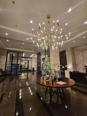 a christmas tree on a table in a lobby at Modern condo near US Embassy in Manila