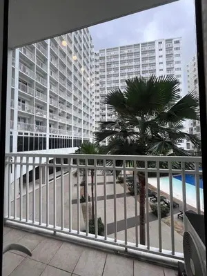 a balcony with a view of the beach and buildings at Biglaang Lakad by Metro Staycation in Manila