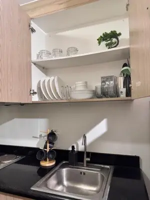 a kitchen with a sink and a counter top at Wander & Chill Staycation in Manila