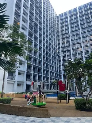 a playground in front of a large building at Wander & Chill Staycation in Manila