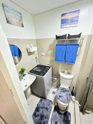 a small bathroom with a toilet and a sink at Wander & Chill Staycation in Manila