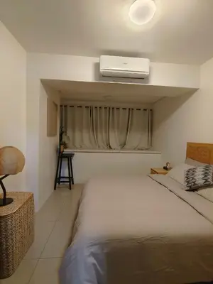 a bedroom with a bed with a air conditioner on the ceiling at Barkada Pamilya BnB by Metro Staycation in Manila