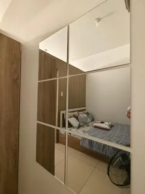 a mirror reflection of a bed in a room at Group Stay by Metro Staycation in Manila